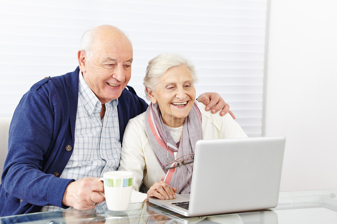 Senior Citizen Couple Using Computer at Home