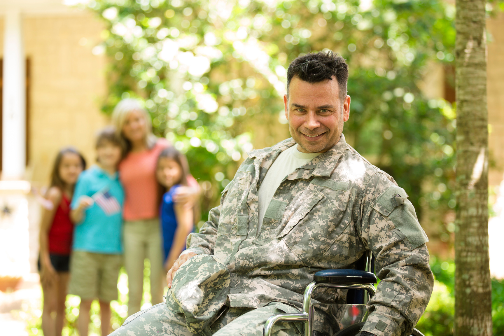 American military veteran welcomed home by family. Wheelchair, disabled. Home.
